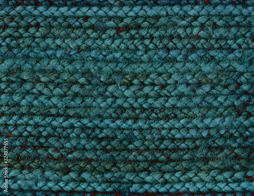 Textured background of a weaving in teal