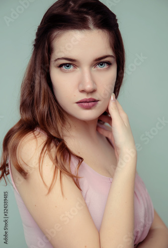 Young brunette woman with blue eyes studio portraot