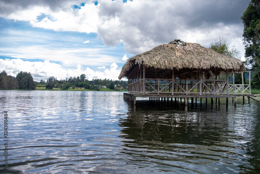 A cabin made of guadua and straw on the shore of the lake in Colombia A cabin made of guadua and straw on the shore of the lake in Colombia