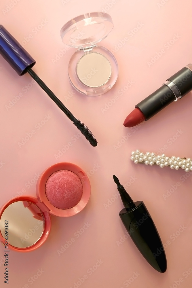 Make-up products on pale pink background: pink blush, mascara, highlighter, lipstick, eyeliner and fashionable beret. Top view. Make-up products on pale pink background: pink blush, mascara, highlighter, lipstick, eyeliner and fashionable beret. Top view.