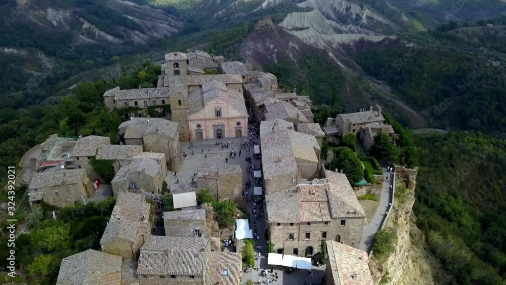 Civita di Bagnoregio town in Tuscany Italy with eroding side cliffs seen frontside, Aerial drone flyover tilt-down shot Civita di Bagnoregio town in Tuscany Italy with eroding side cliffs seen frontside, Aerial drone flyover tilt-down shot