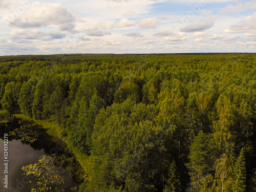 Aerial shooting of a magic lake in the taiga of Russia