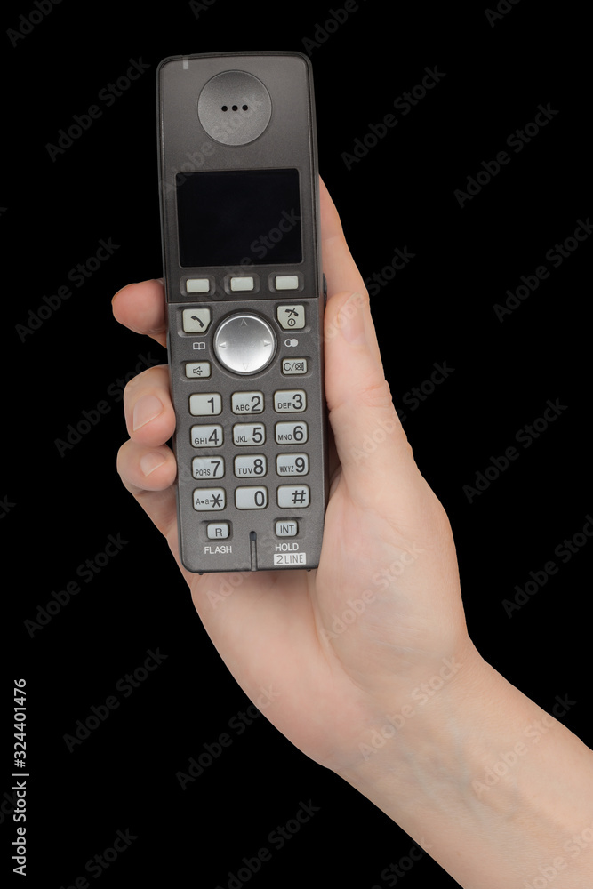 Female hand holds a phone, isolated on black background Female hand holds a phone, isolated on black background