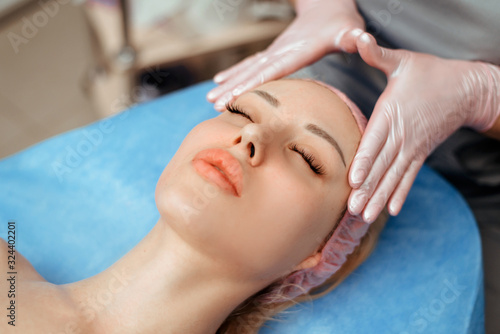 face massage on woman in the spa salon