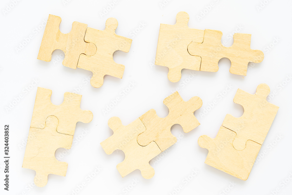 Fototapeta premium wooden jigsaw puzzle pieces on white background