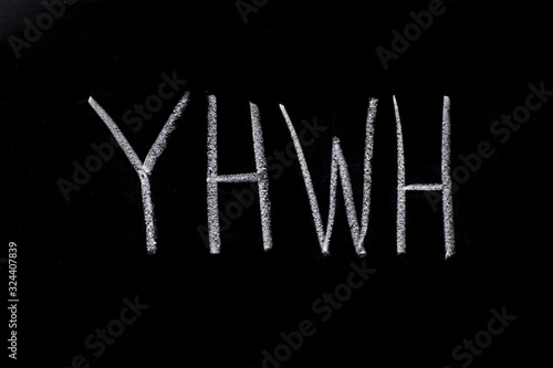 YHWH written in chalk on chalkboard photo