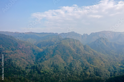 High angle scenic view of mountain against foggy sky 