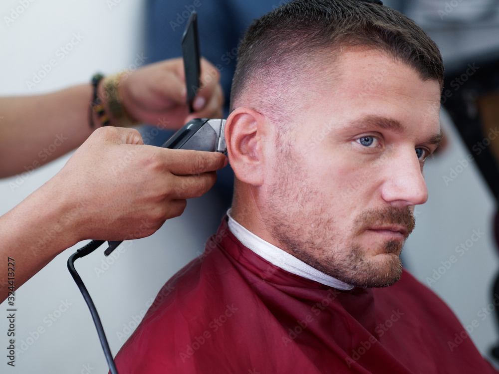 Male client getting haircut by hairdresser.. Male client getting haircut by hairdresser..