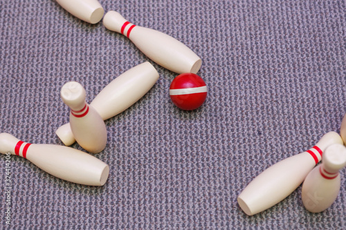 Red mini bowling ball and pins.