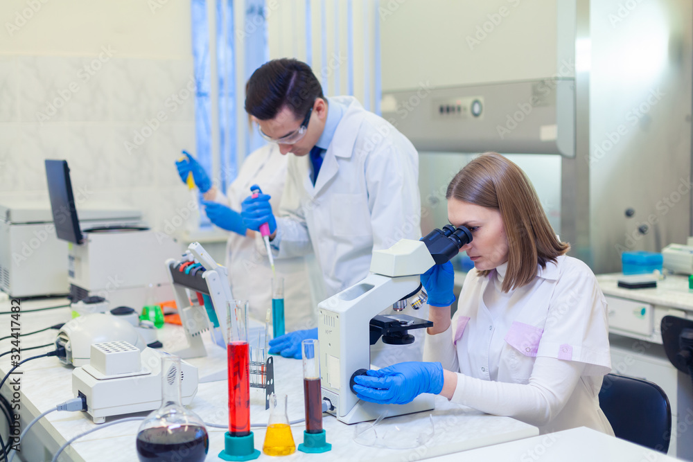 A group of scientists conducts research in a scientific laboratory using advanced technology. A group of scientists conducts research in a scientific laboratory using advanced technology.