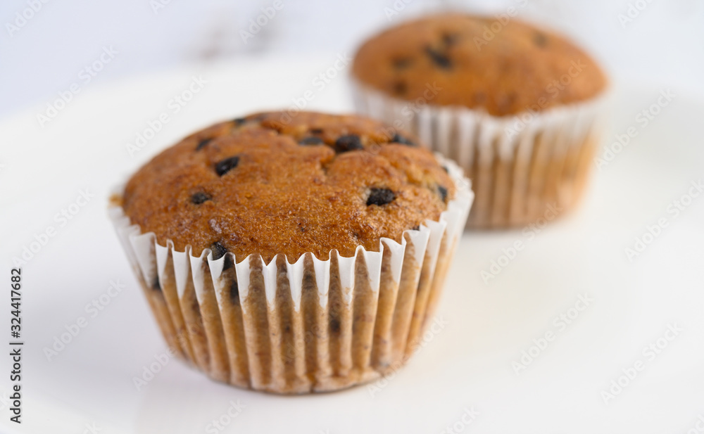 Banana cupcakes mixed with chocolate chip on a white plate. Banana cupcakes mixed with chocolate chip on a white plate.