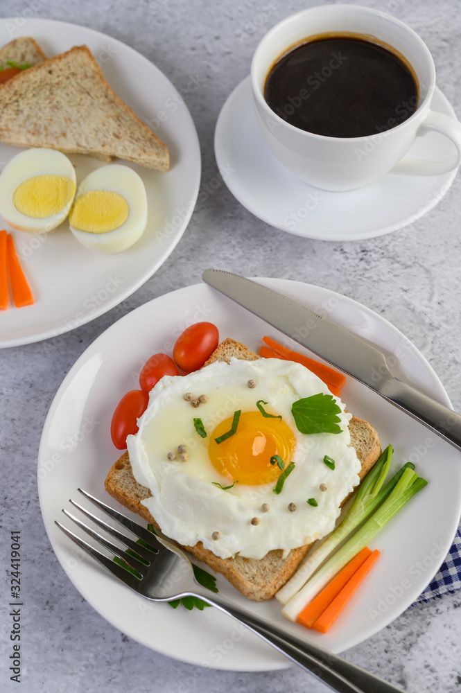 A fried egg laying on a toast, topped with pepper seeds with carrots and spring onions. A fried egg laying on a toast, topped with pepper seeds with carrots and spring onions.