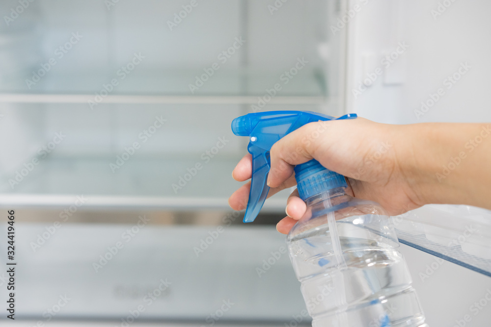 Asian women cleaning and disinfecting refrigerator Asian women cleaning and disinfecting refrigerator