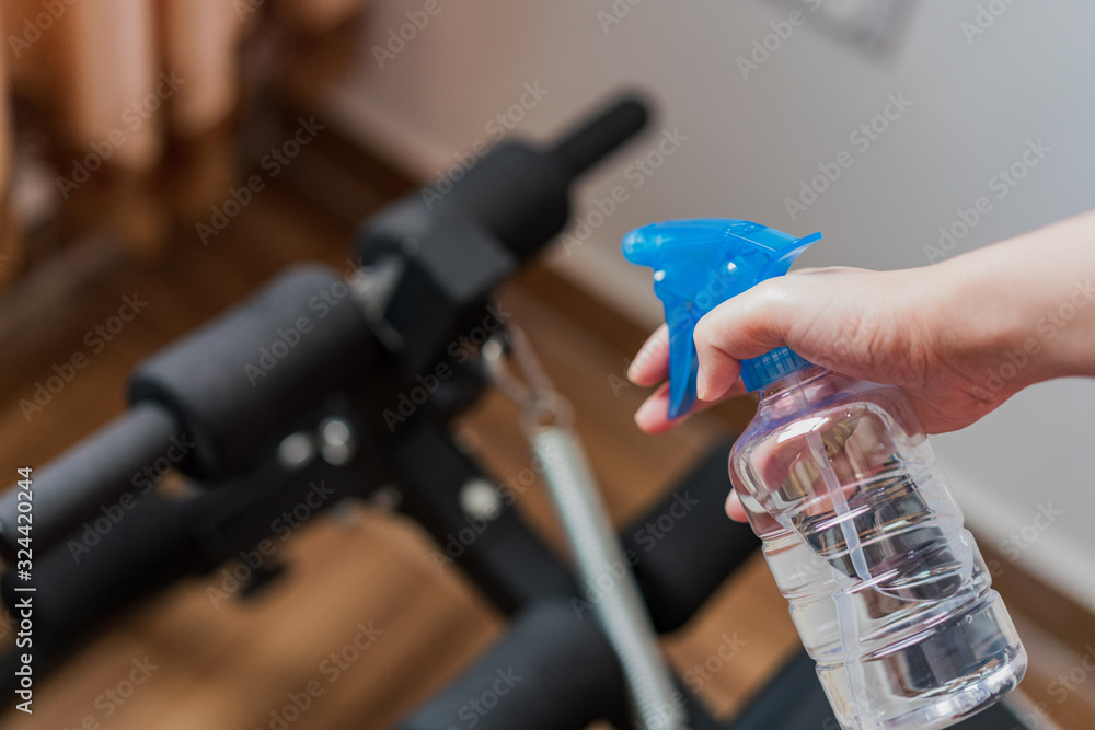 Fototapeta premium Asian women cleaning and disinfecting fitness equipment