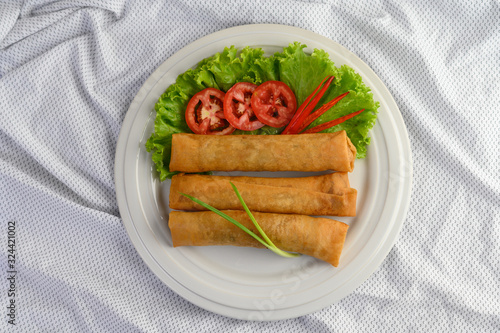 Egg roll or Fried Spring Rolls on the white plate Thai food. Top view.