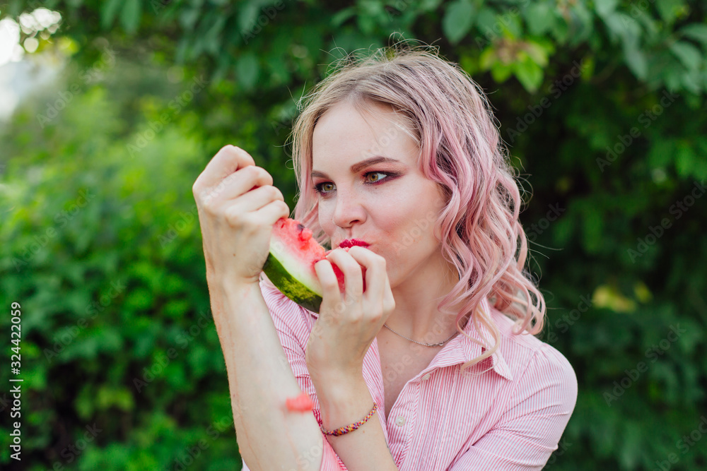 Beautiful young woman with pink hair enjoying watermelon Beautiful young woman with pink hair enjoying watermelon