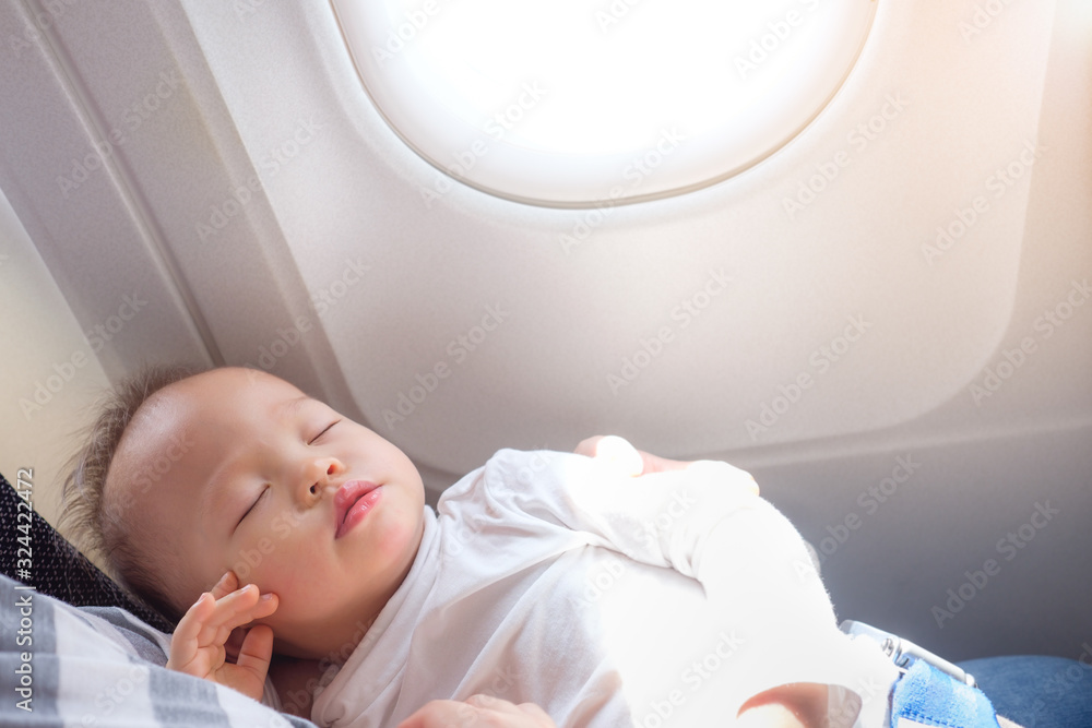 Φωτογραφία Cute little Asian 18 months / 1 year old toddler baby boy child sleeping on Airp