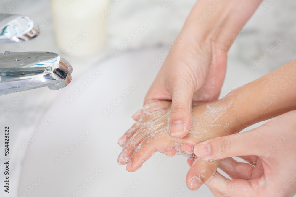 Young asian woman washing hands for her son Young asian woman washing hands for her son