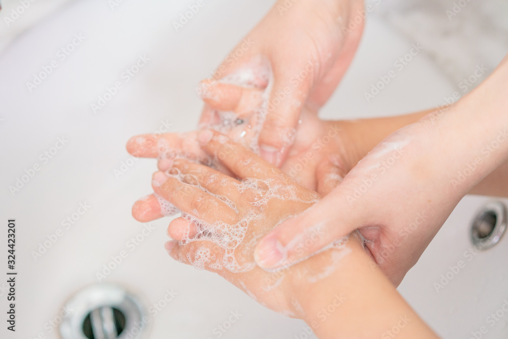 Young asian woman washing hands for her son Young asian woman washing hands for her son