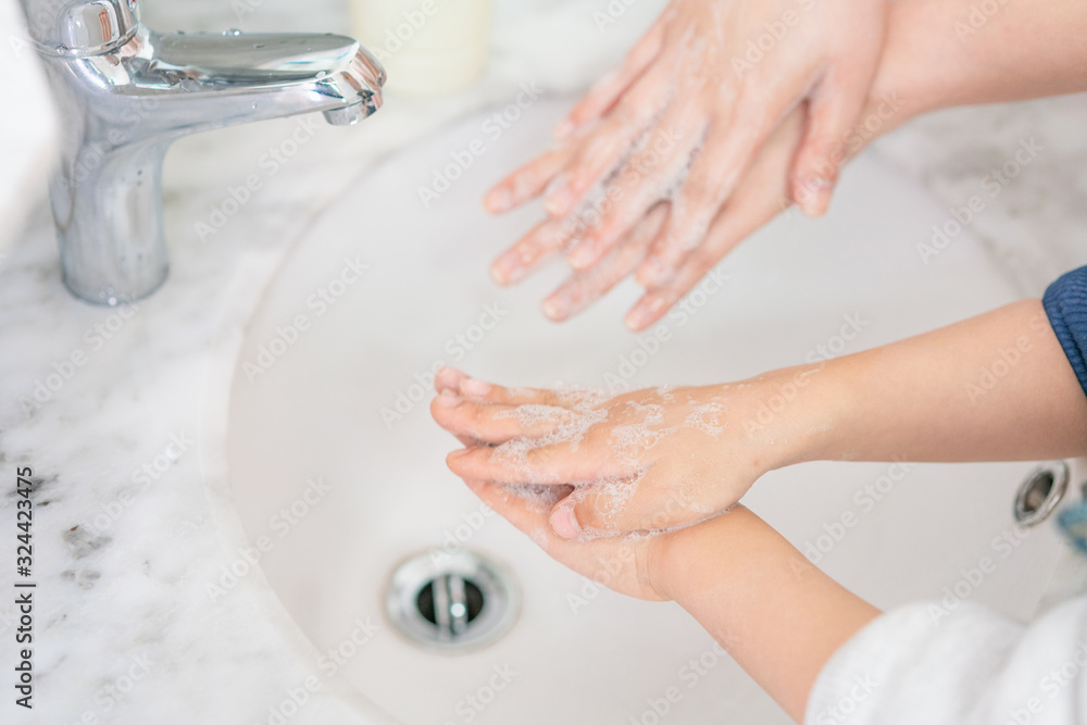 Young asian woman washing hands for her son Young asian woman washing hands for her son