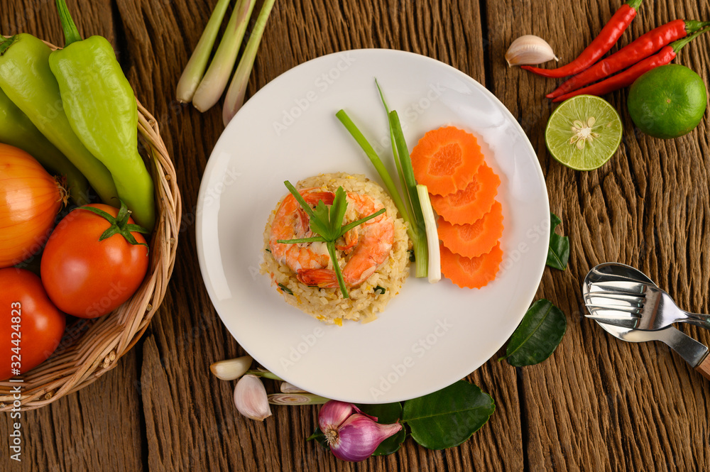 Shrimp fried rice on a white plate on a wooden table Shrimp fried rice on a white plate on a wooden table