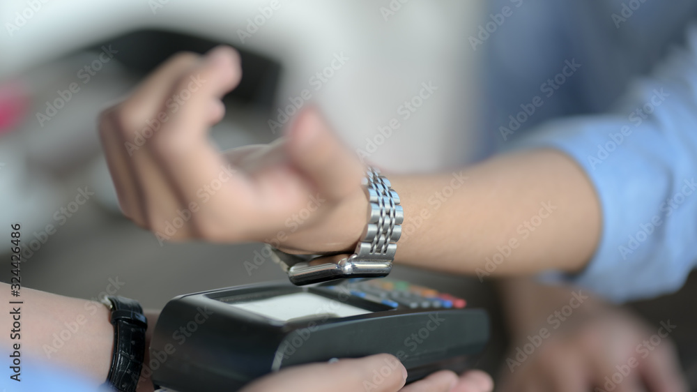 Cropped shot of male customer paying by online banking application