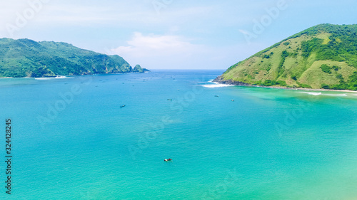 Aerial drone  bird s eye view photo from north of Mawun beach  Lombok Island  Indonesia. Green hills and blue sky. View of another side of mandalika circuit in Lombok. Background of beach Lombok.