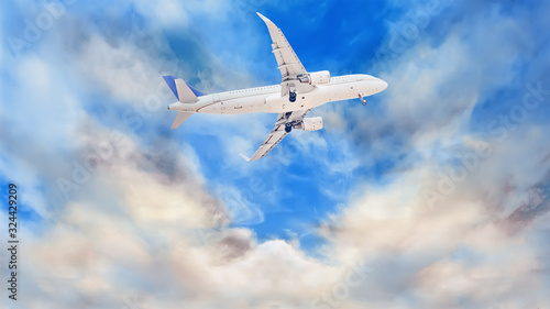 A white passenger plane that has just taken off against a background of beautiful and dramatic clouds. Extended landing gear
