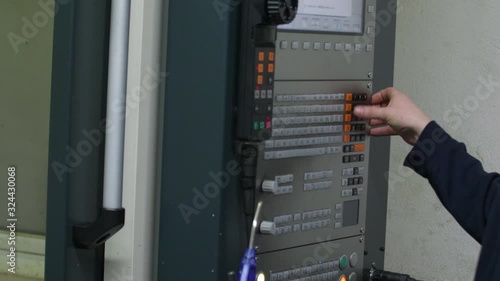 Lathe and milling full auto CNC machine man uses panel to progam machine. Nr.2 4k 50p 10bit AppleProRes photo