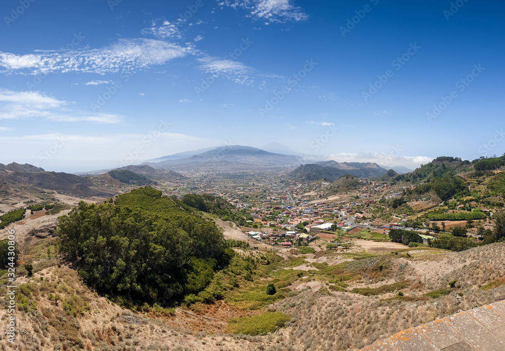 Panoramic image of small town on the mountain slope at valley