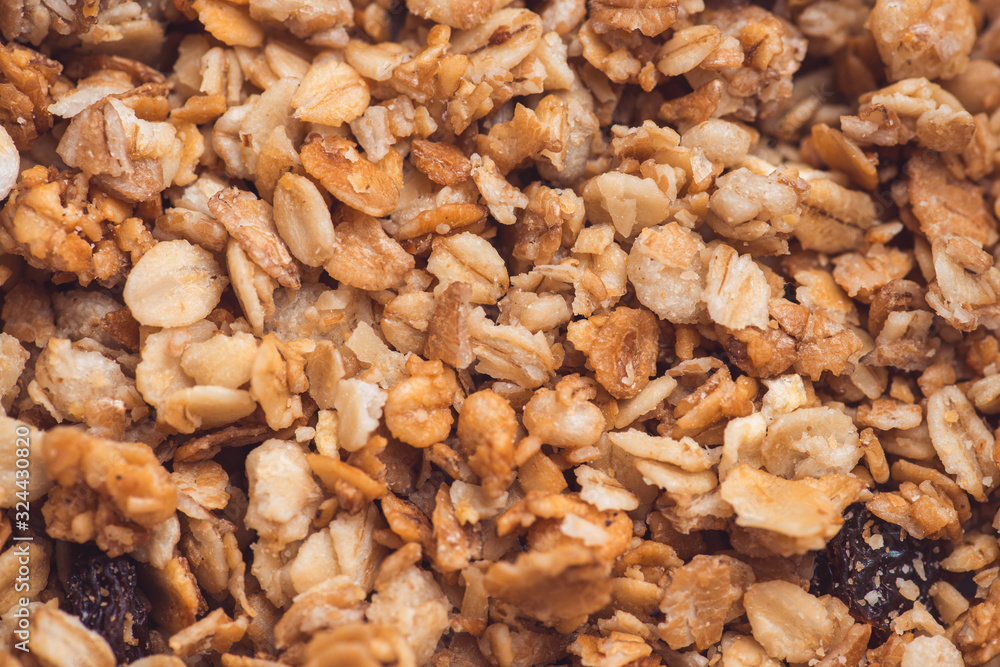 Useful and tasty muesli with nuts, rasins and flakes. Selective focus macro shot with very shallow depth of field. Healthy and vegetarian lifestyle Useful and tasty muesli with nuts, rasins and flakes. Selective focus macro shot with very shallow depth of field. Healthy and vegetarian lifestyle