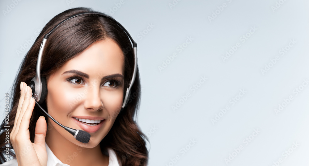 Portrait of cheerful customer support female phone operator in headset Portrait of cheerful customer support female phone operator in headset