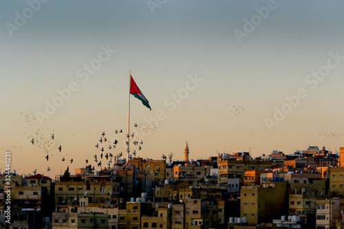 Amman, Jordan sunset with flagpole and birds