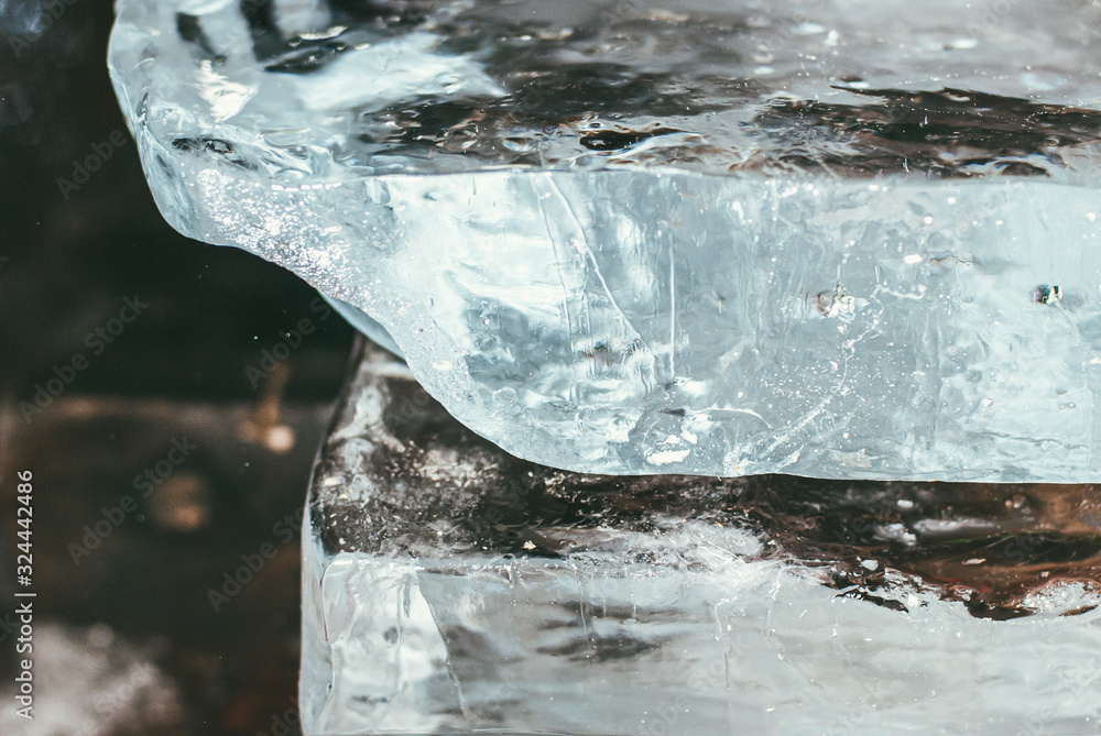 Huge blocks of clear pieces of ice one on top of the other for ice sculpture. Selective focus macro shot with shallow DOF Huge blocks of clear pieces of ice one on top of the other for ice sculpture. Selective focus macro shot with shallow DOF