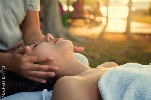 Beautiful Asian female relaxing holiday With a spa by the sea. Relax concept.