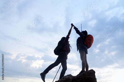 Two climber helping to hike up . Concept for success ,help , teamwork and Leadership concept . 