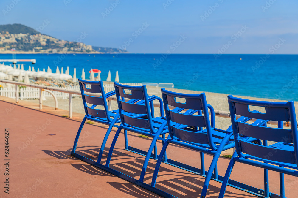 Blue chairs on the Promenade des Anglais in Nice France
