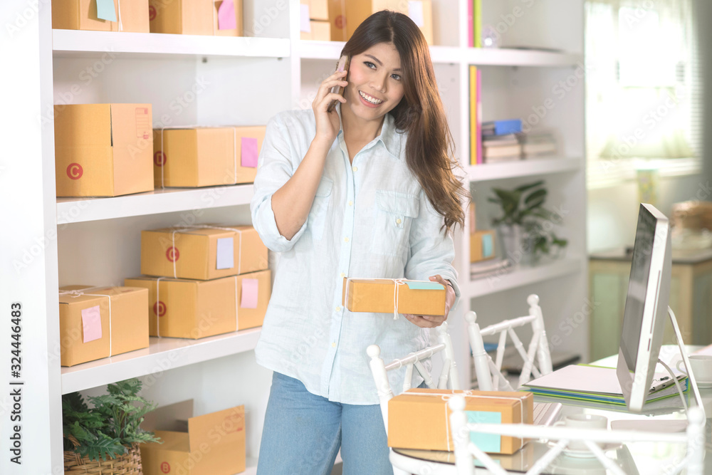 asian business woman work at home office checking order ready to mailing or shipping on computer.successful small business owner concept asian business woman work at home office checking order ready to mailing or shipping on computer.successful small business owner concept