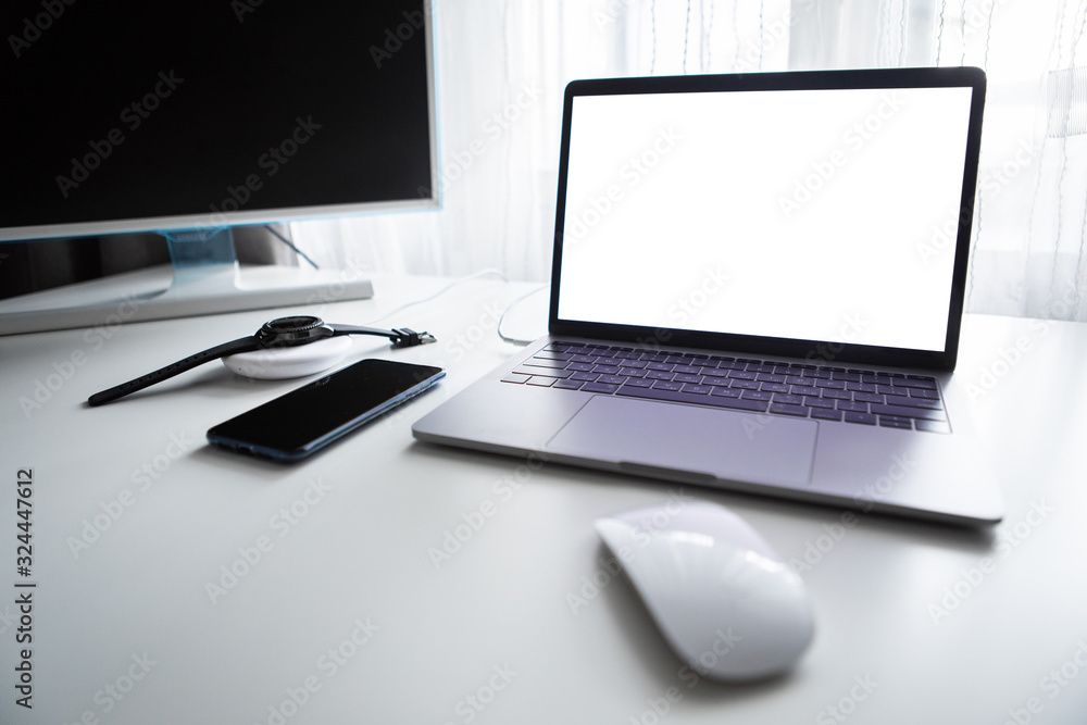 laptop with phone computer mouse and smart watch charging on wireless charger laptop with phone computer mouse and smart watch charging on wireless charger