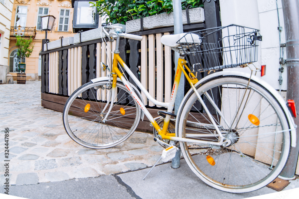 old retro yellow bike at european city street