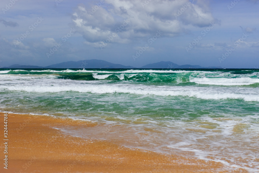 Empty long beach with a beautiful sea view. White foam from a sea wave Empty long beach with a beautiful sea view. White foam from a sea wave