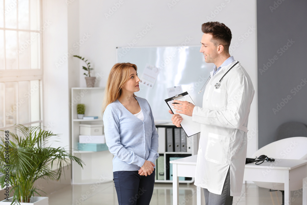 Mature woman visiting male cardiologist in clinic Mature woman visiting male cardiologist in clinic