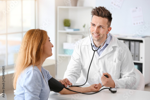 Male cardiologist examining...