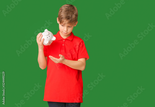 Cute boy tipping money from...