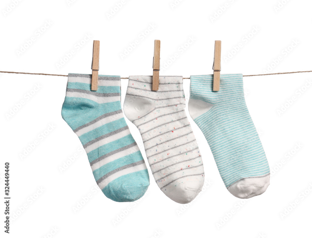 Cotton socks hanging on rope against white background Cotton socks hanging on rope against white background