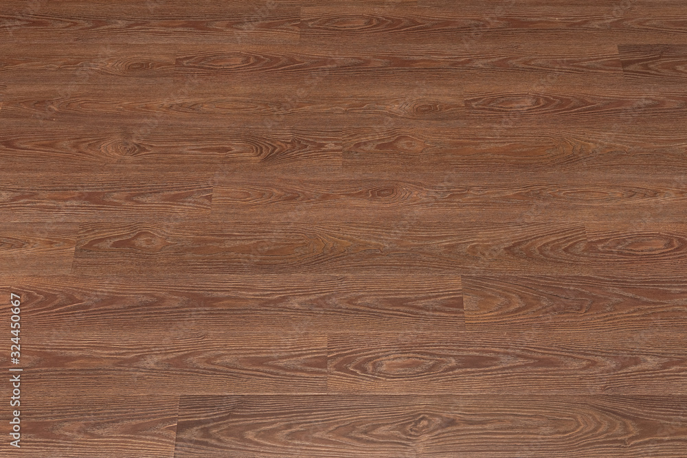 Naklejka premium Natural dark brown wooden surface floor texture background. polished laminate parquet