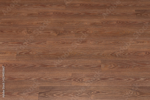 Natural dark brown wooden surface floor texture background. polished laminate parquet