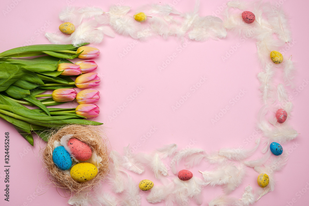 Easter pink background with chocolate, easter eggs, tulips, feathers
