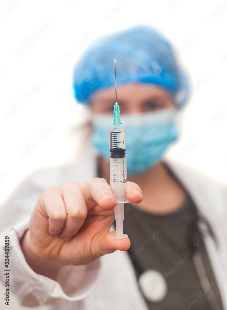 nurse woman holding syringe for virus protection. focus on the hand nurse woman holding syringe for virus protection. focus on the hand