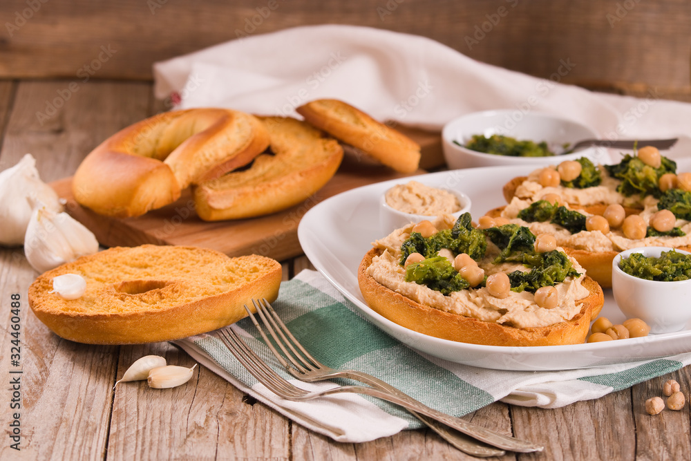 Friselle with turnip tops and hummus. Friselle with turnip tops and hummus.